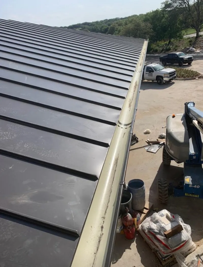 Standing seam panel and gutter detail on a metal roofing jobsite in Holdrege